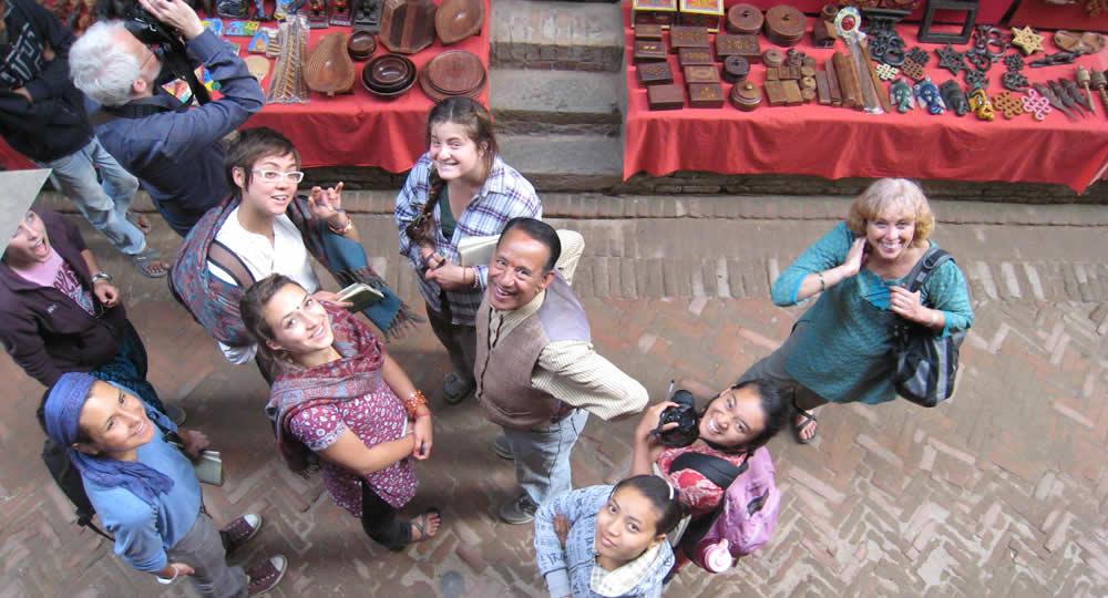Pitzer group in Nepal market look up at the camera.